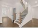 Beautiful staircase with wooden railings, leading to the upper level of the home at 1715 Goodwin Dr, Hampton, GA 30228