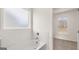 Bathroom with soaking tub and subway tile, view to bedroom with natural light at 663 Edgar St # 25, Hampton, GA 30228