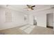 Light-filled bedroom with neutral carpeting and adjacent bathroom with wood-look tile floors at 663 Edgar St # 25, Hampton, GA 30228