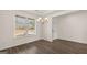 Sunlit dining room featuring hardwood floors, elegant lighting, and a view of the outdoors at 663 Edgar St # 25, Hampton, GA 30228