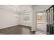 Elegant dining room with coffered ceiling, modern chandelier, and large window with natural light at 663 Edgar St # 25, Hampton, GA 30228