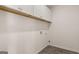 A laundry room featuring tile floors and white cabinets at 663 Edgar St # 25, Hampton, GA 30228