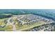 Aerial view of a well-planned community with neatly arranged homes, sidewalks, and green spaces at 659 Edgar Dr, Hampton, GA 30228