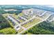 Aerial view of a sprawling community with a pool, tree-lined streets, and well-maintained landscaping at 659 Edgar Dr, Hampton, GA 30228