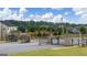 Community entrance with black metal gate and manicured landscaping at 659 Edgar Dr, Hampton, GA 30228