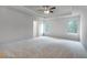 Large main bedroom with two large windows and neutral colored carpet at 659 Edgar Dr, Hampton, GA 30228