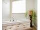 Bright bathroom featuring a soaking tub with jets and natural light at 347 Cobblestone Ct, Hampton, GA 30228