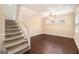 Finished basement with dark wood-look floors, carpeted stairs, neutral walls, and natural light from above ground windows at 3435 Misty Valley Rd, Decatur, GA 30032