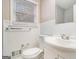 Well-lit bathroom with a white vanity, toilet, wainscoting, and a window featuring natural light and ventilation at 3435 Misty Valley Rd, Decatur, GA 30032