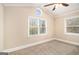 Bright bedroom with neutral carpet, vaulted ceilings, a ceiling fan, and multiple windows offering natural light and outdoor views at 3435 Misty Valley Rd, Decatur, GA 30032