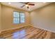 Well-lit bedroom with wood floors and ceiling fan at 2436 Green Hollow Ct, Conyers, GA 30012