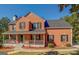 Brick two-story house with gray roof, porch, and landscaping at 2436 Green Hollow Ct, Conyers, GA 30012