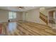 Hardwood floor living room with fireplace and view of kitchen at 2436 Green Hollow Ct, Conyers, GA 30012