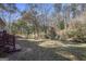 Leaf-covered backyard featuring a wooded area in the background, creating a natural privacy screen at 1471 Cedar Creek Ln, Riverdale, GA 30296