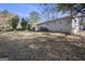 Large, leaf-covered backyard featuring a modest single-Gathering home, ready for outdoor activities at 1471 Cedar Creek Ln, Riverdale, GA 30296