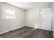 Well-lit bedroom offers wood-look floors and neutral paint at 1471 Cedar Creek Ln, Riverdale, GA 30296