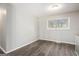 Cozy bedroom with neutral paint, updated flooring, and a bright window at 1471 Cedar Creek Ln, Riverdale, GA 30296