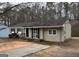 Traditional ranch style home with neutral siding, black shutters, and a concrete driveway at 1471 Cedar Creek Ln, Riverdale, GA 30296