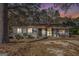 Charming single-story home with a covered front porch and manicured shrubbery at 1471 Cedar Creek Ln, Riverdale, GA 30296