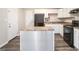 Bright kitchen featuring white cabinets, updated countertops, and stainless steel appliances at 1471 Cedar Creek Ln, Riverdale, GA 30296