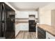 Functional kitchen featuring sleek gray floors, white cabinets, and stainless steel appliances at 1471 Cedar Creek Ln, Riverdale, GA 30296