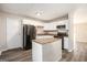Eat-in kitchen with white cabinetry, stainless steel appliances, and an island at 1471 Cedar Creek Ln, Riverdale, GA 30296