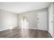 Bright living room featuring sleek gray wood-look flooring, neutral walls and ample natural light at 1471 Cedar Creek Ln, Riverdale, GA 30296