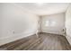 Bright living room features wood-look floors and natural light from a window at 1471 Cedar Creek Ln, Riverdale, GA 30296