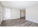 Open living room featuring sleek gray wood-look flooring, neutral walls, and white trim at 1471 Cedar Creek Ln, Riverdale, GA 30296