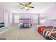 Bedroom with two bunk beds, ceiling fan, and light pink walls at 209 Enfield Ln, Mcdonough, GA 30252