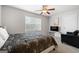 Bedroom with a queen bed, window, ceiling fan, and small seating area at 209 Enfield Ln, Mcdonough, GA 30252