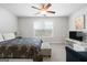 Bedroom with a queen bed, window, ceiling fan, and small seating area at 209 Enfield Ln, Mcdonough, GA 30252