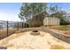 Stone fire pit with seating area in backyard at 209 Enfield Ln, Mcdonough, GA 30252