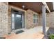 Front door entrance with brick columns and flooring at 209 Enfield Ln, Mcdonough, GA 30252