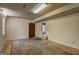 The basement is spacious with a concrete floor, a window, and a wooden door at 3954 Swathmore Ln, Duluth, GA 30096