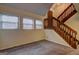 Bright living room featuring a staircase with wood railings and a set of windows at 3954 Swathmore Ln, Duluth, GA 30096