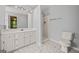 Well-lit bathroom with a single vanity, marble floors, and walk-in shower at 65 Riverside Way, Sharpsburg, GA 30277