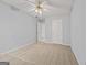 Comfortable bedroom featuring a ceiling fan, neutral carpet, and bright white doors at 65 Riverside Way, Sharpsburg, GA 30277