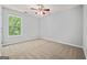 Comfortable bedroom featuring a ceiling fan, neutral carpet, and bright windows at 65 Riverside Way, Sharpsburg, GA 30277