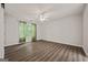 Spacious bedroom featuring hardwood floors, a ceiling fan, and natural light from the window at 65 Riverside Way, Sharpsburg, GA 30277