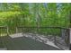 Spacious wooden deck overlooking a lush green forest, perfect for outdoor relaxation and enjoying nature at 65 Riverside Way, Sharpsburg, GA 30277