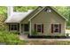 Charming single-story home with a manicured lawn, tan siding, and contrasting red shutters at 65 Riverside Way, Sharpsburg, GA 30277