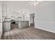 Open-concept kitchen with modern countertops, stainless steel appliances, and ample counter space at 65 Riverside Way, Sharpsburg, GA 30277