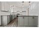 Modern kitchen boasts white cabinetry, stainless steel appliances, and stylish pendant lighting at 65 Riverside Way, Sharpsburg, GA 30277