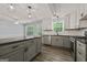 Modern kitchen features updated appliances, ample counter space, and gray cabinets at 65 Riverside Way, Sharpsburg, GA 30277