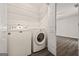 Convenient laundry room equipped with washer, dryer, and ample storage shelving at 65 Riverside Way, Sharpsburg, GA 30277