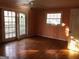 Bedroom featuring hardwood floors, natural light from windows, and access to the backyard at 138 Le Brun Ne Rd, Atlanta, GA 30342