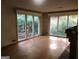Sunlit living room features hardwood floors, a brick fireplace, and a large window view at 138 Le Brun Ne Rd, Atlanta, GA 30342