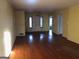 Spacious living room featuring hardwood floors and natural light through entry and window at 138 Le Brun Ne Rd, Atlanta, GA 30342