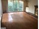 Living room featuring hardwood floors, a brick fireplace, and a wall of windows at 138 Le Brun Ne Rd, Atlanta, GA 30342